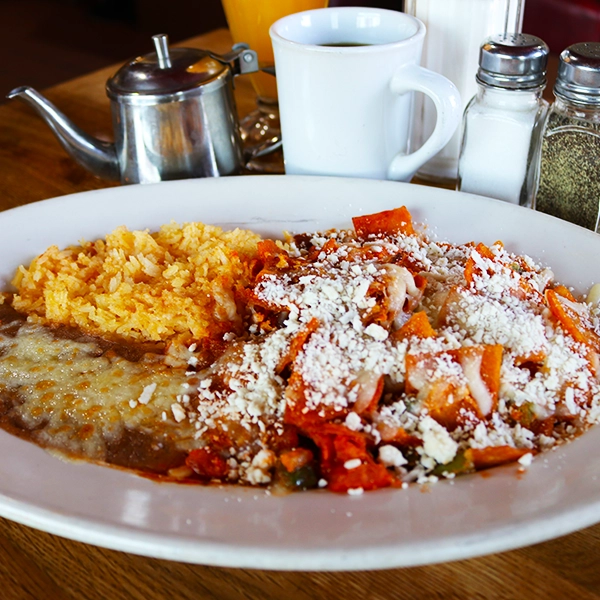 traditional style chilaquiles, served with red or green sauce with a side of beans and rice