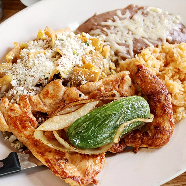a savory mix with grilled chicken brest with chilaquiles tortilla chips, served with rice and beans