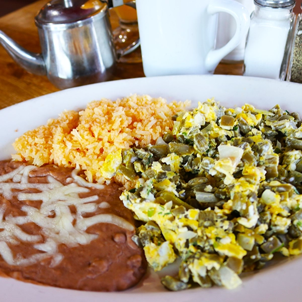 mexican style eggs with nopales with a side of beans and rice