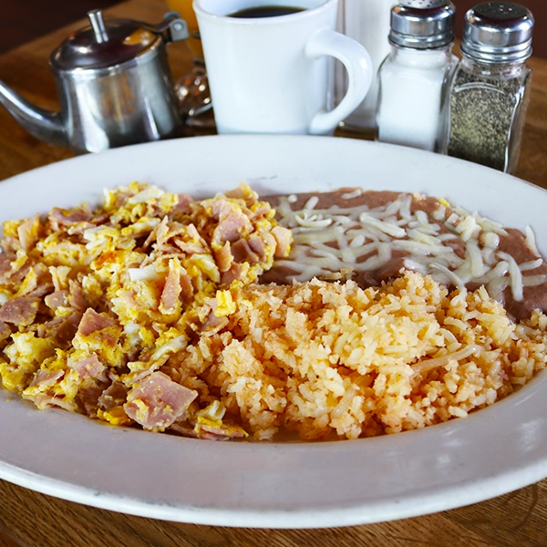 traditional home made eggs with ham with a side of beans and rice