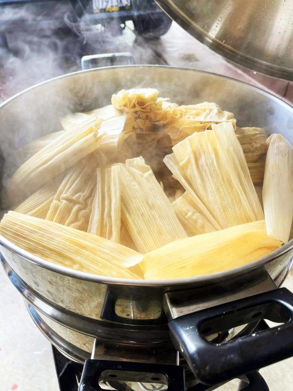 authentic mexican tamales, pork filled covered in corn leafs